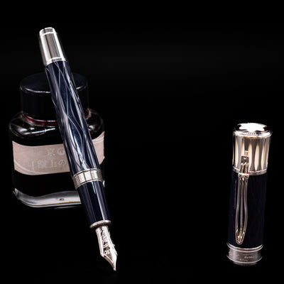 Montblanc Writer's Edition Mark Twain Fountain Pen - Preowned leaning on an ink bottle uncapped showcasing the detailing on the nib.