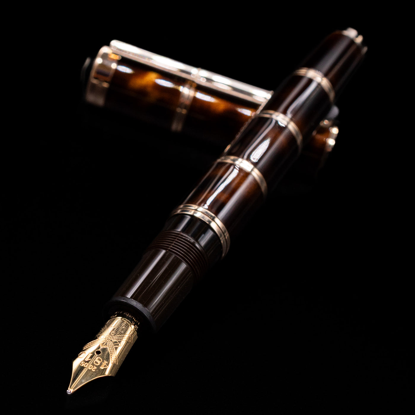 Montblanc Writer's Edition Miguel de Cervantes Fountain Pen - Preowned laying across its own cap, crossed, with a focus on the nib.