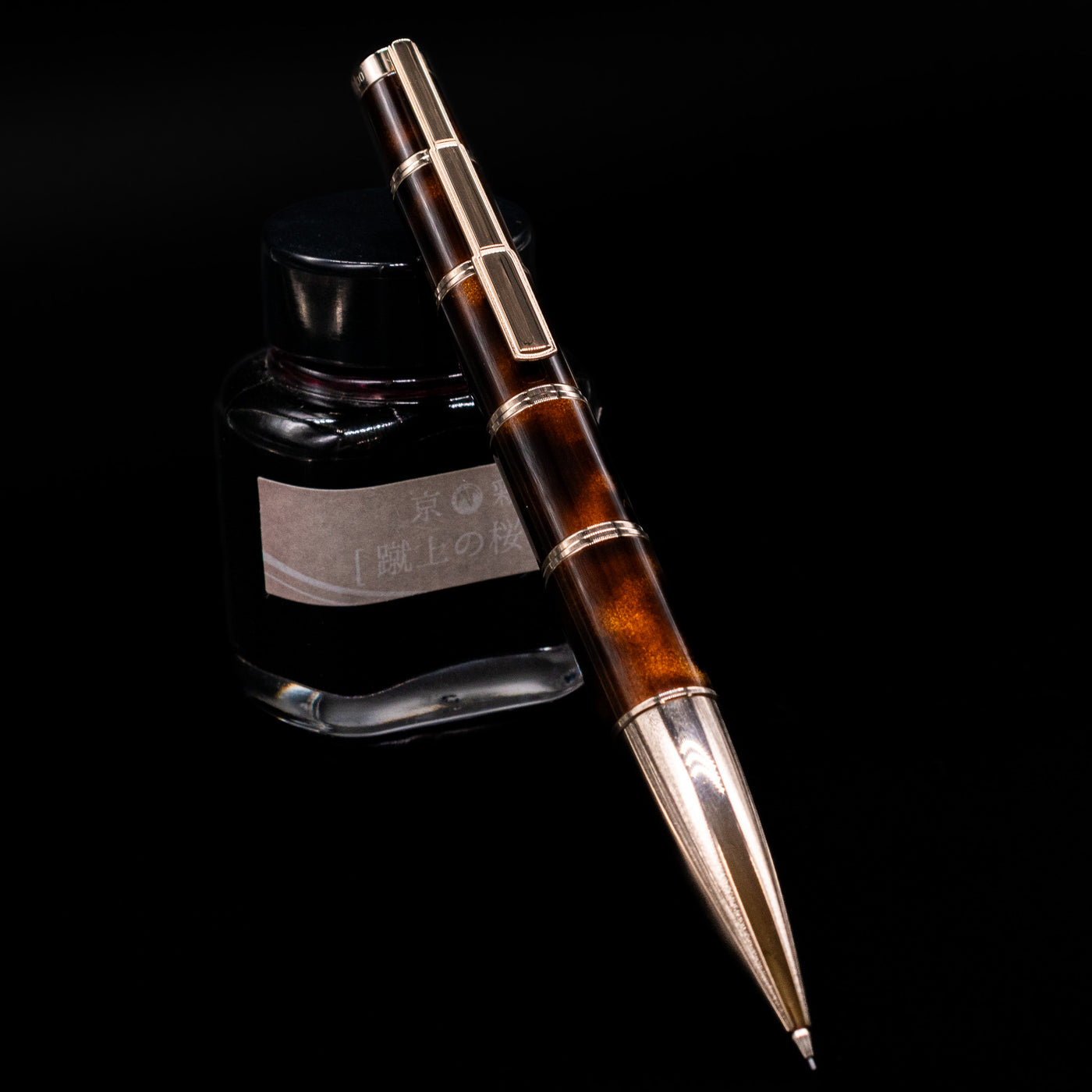 Montblanc Writer's Edition Miguel de Cervantes Mechanical Pencil - Preowned leaning on an ink bottle.