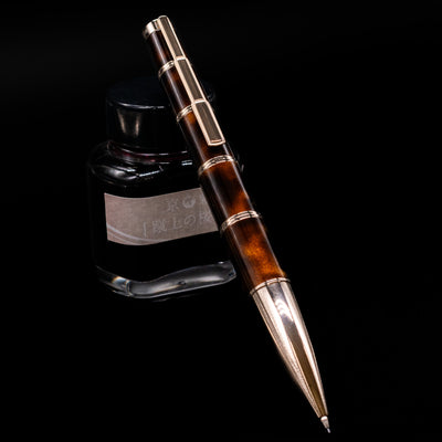 Montblanc Writer's Edition Miguel de Cervantes Mechanical Pencil - Preowned leaning on an ink bottle.
