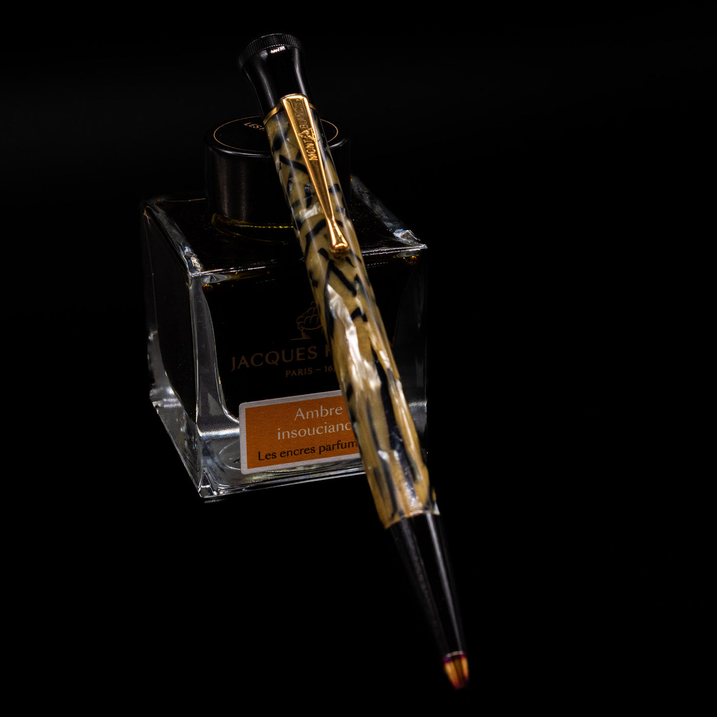 Montblanc Writer's Edition Oscar Wilde Ballpoint Pen - Preowned leaning on an ink bottle.