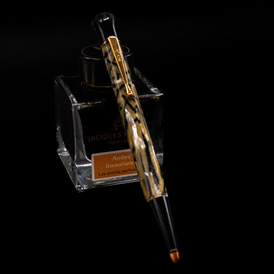 Montblanc Writer's Edition Oscar Wilde Ballpoint Pen - Preowned leaning on an ink bottle.