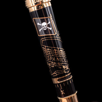 A detail shot of the body of the Montblanc Writer's Edition Robert Louis Stevenson Limited Edition 1833 Rollerball Pen - Preowned showcasing its pirate flag and the Hispaniola boat.