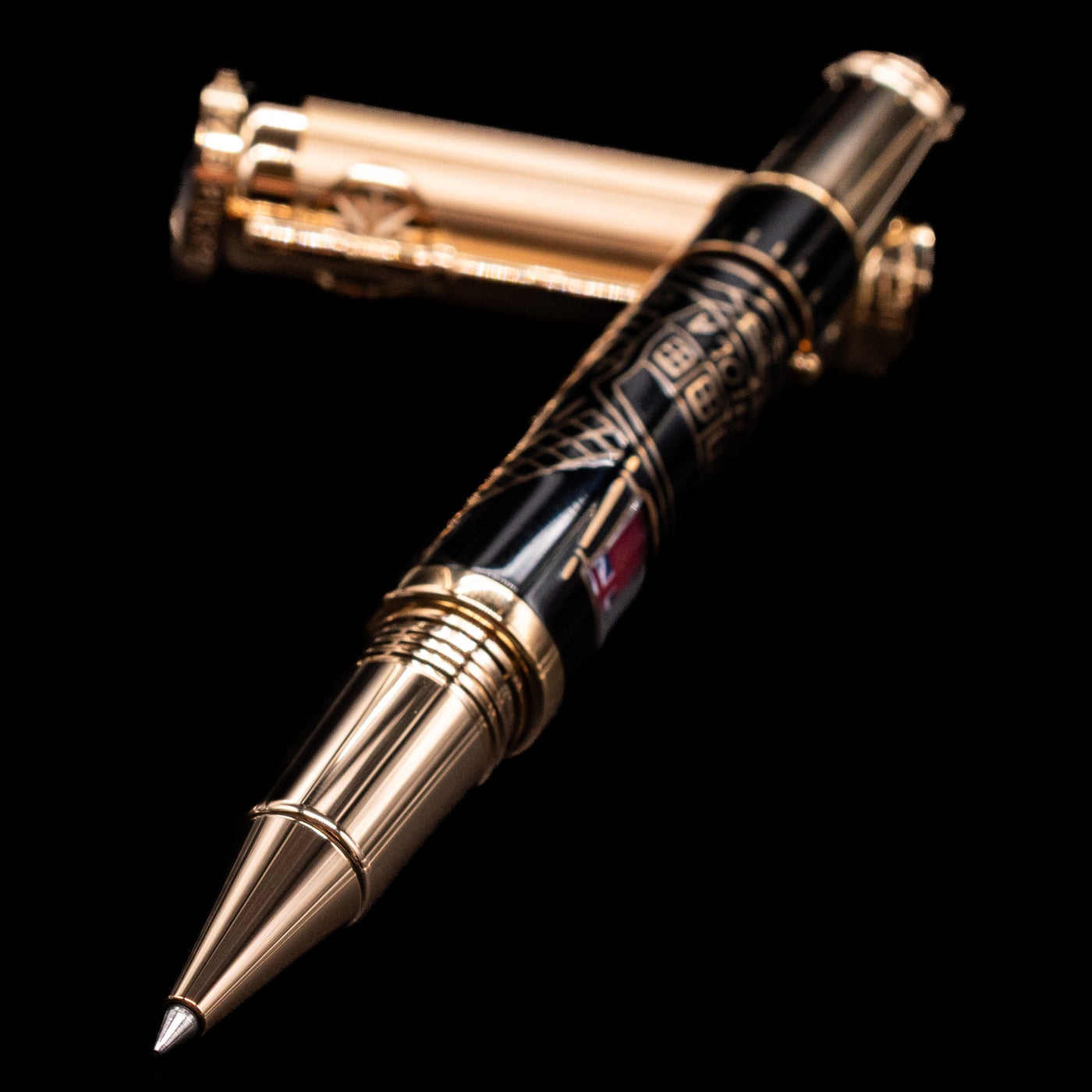 Montblanc Writer's Edition Robert Louis Stevenson Limited Edition 1833 Rollerball Pen - Preowned laying across its own cap, crossed, with a focus on the tip.