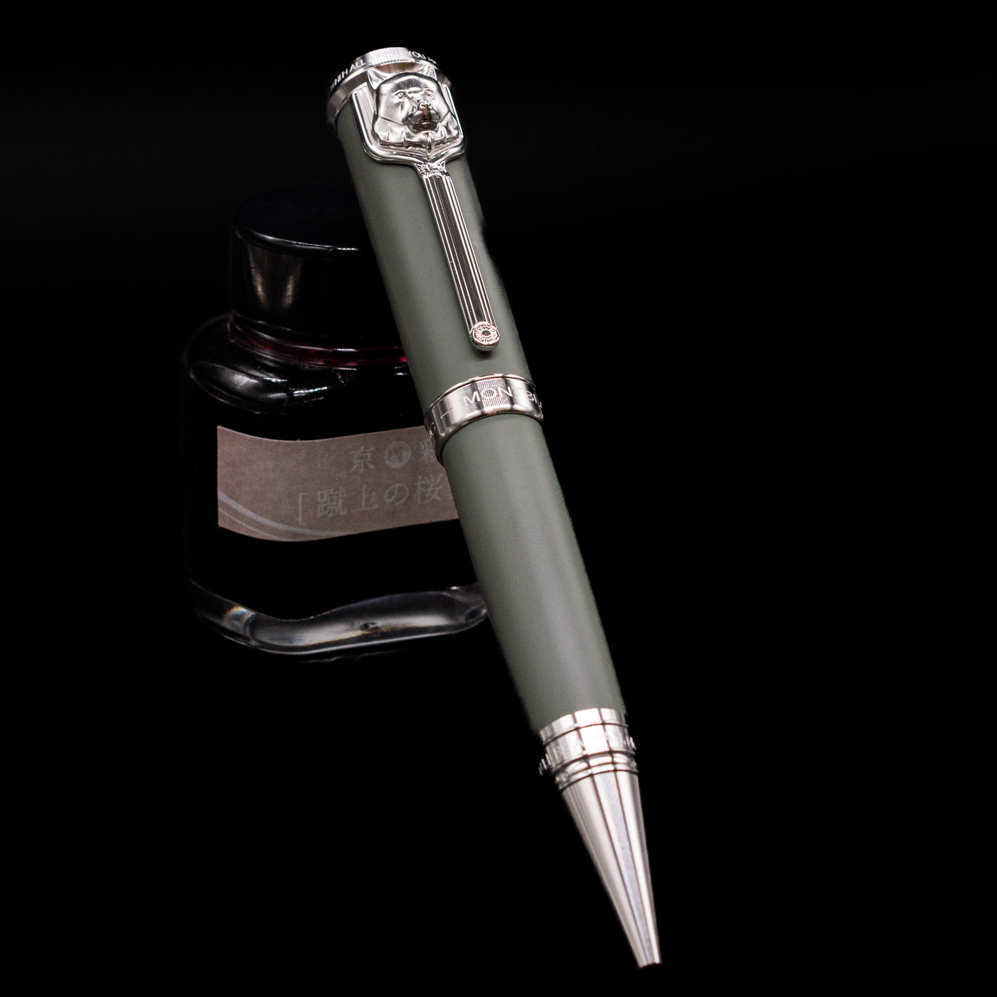 Montblanc Writer's Edition Rudyard Kipling Ballpoint Pen - Preowned leaning on an ink bottle uncapped.