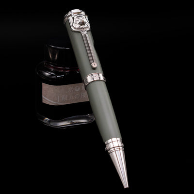 Montblanc Writer's Edition Rudyard Kipling Ballpoint Pen - Preowned leaning on an ink bottle uncapped.
