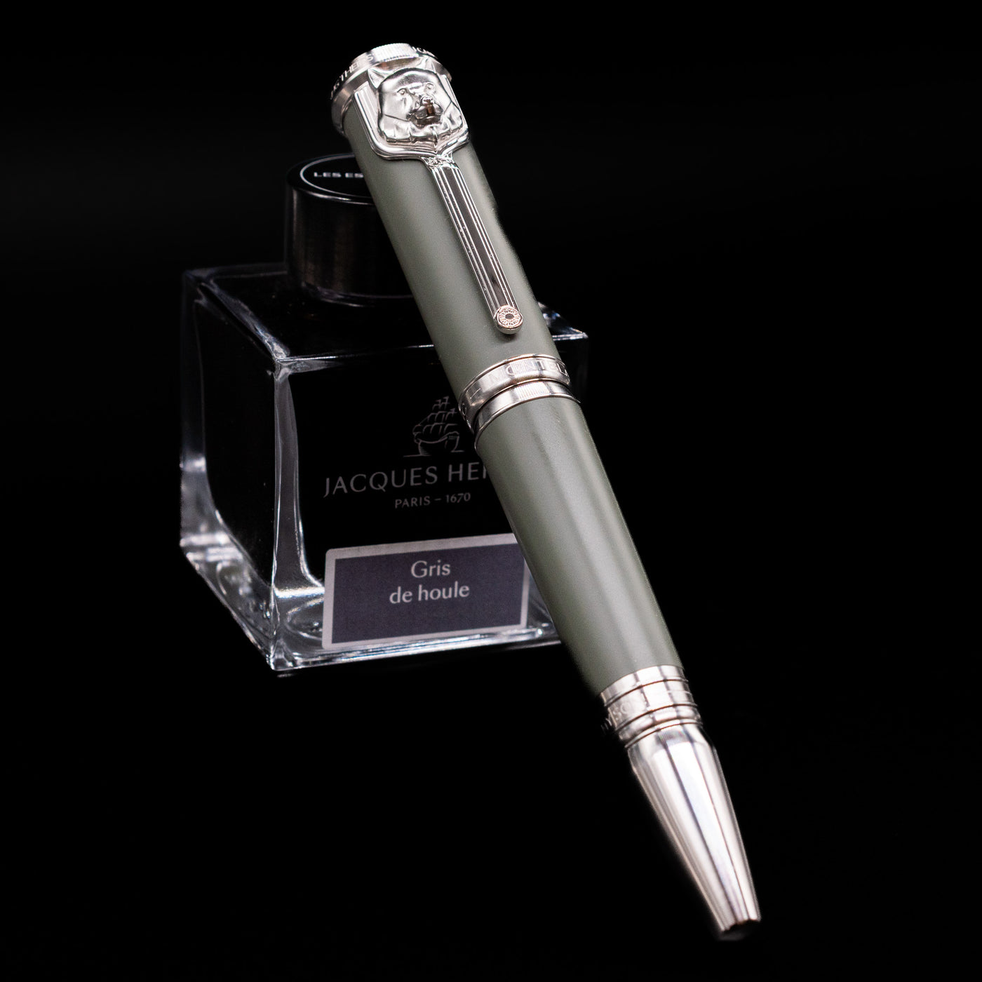 Montblanc Writer's Edition Rudyard Kipling Fountain Pen - Preowned capped, leaning against an ink bottle. 