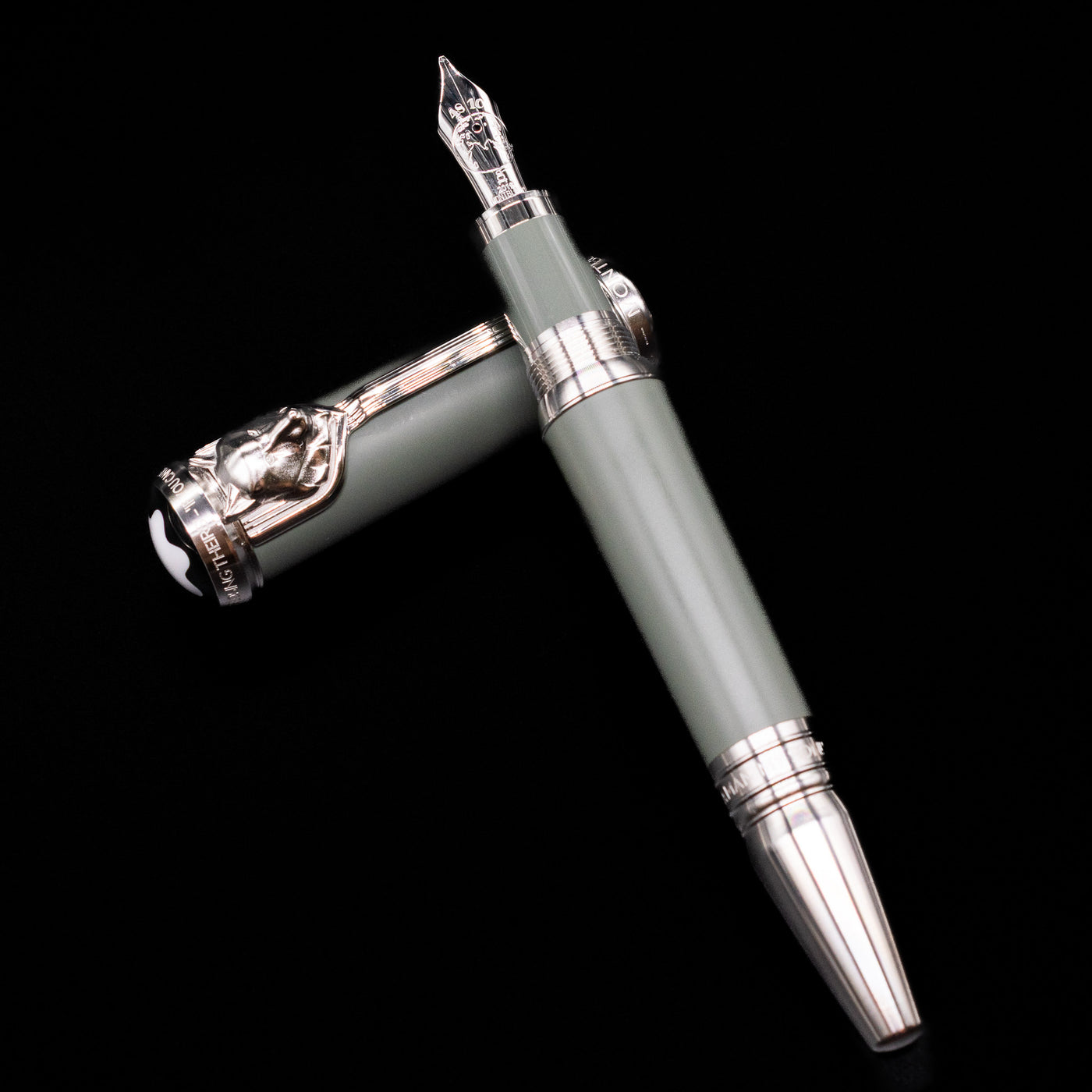 Montblanc Writer's Edition Rudyard Kipling Fountain Pen - Preowned laying on top of its cap in a crossed position showing full view of the entire uncapped pen.