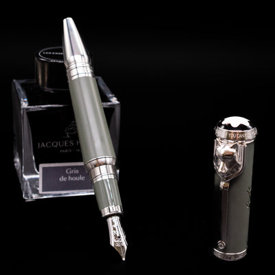 Montblanc Writer's Edition Rudyard Kipling Fountain Pen - Preowned leaning on an ink bottle uncapped showcasing the detailing on the nib.