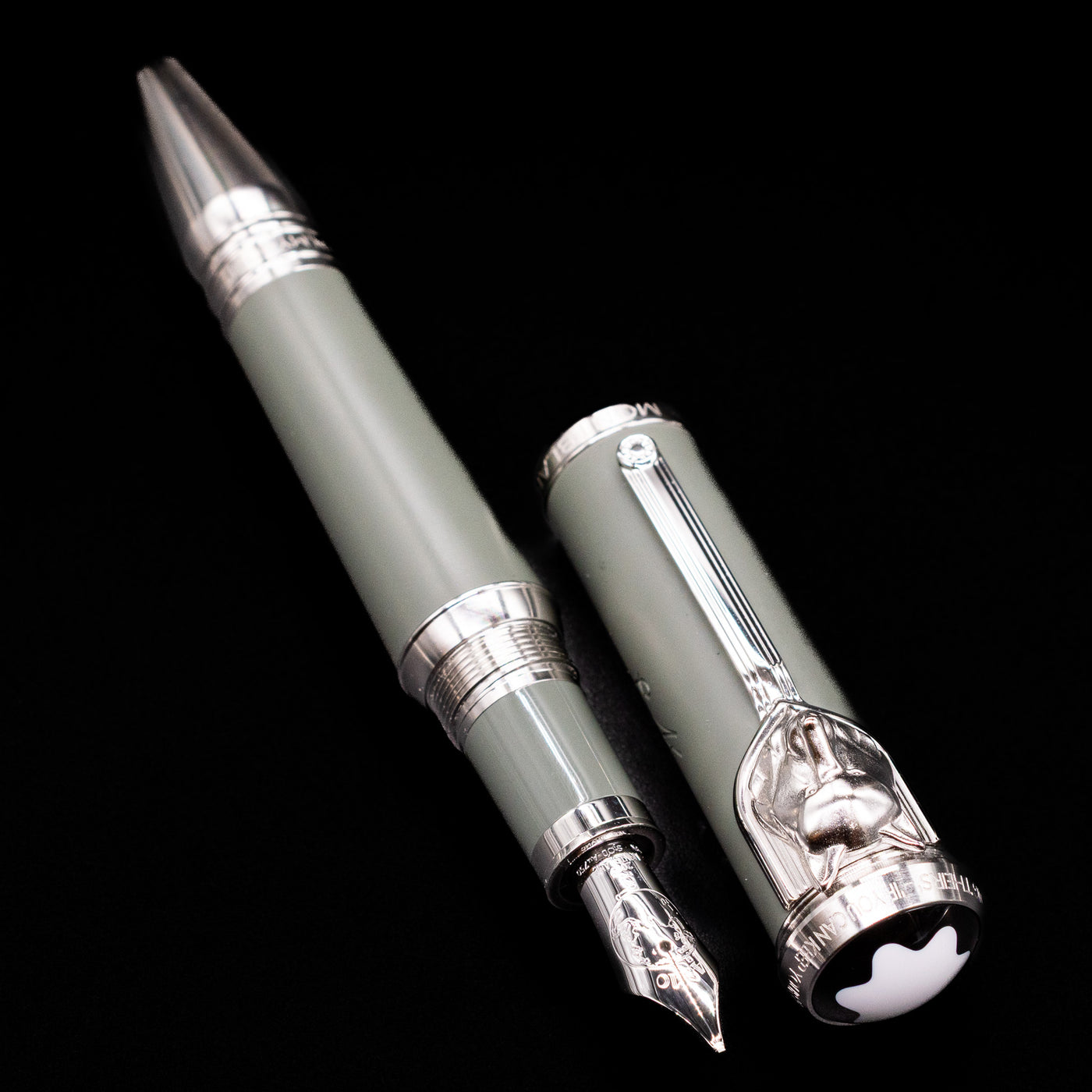 A full view of the Montblanc Writer's Edition Rudyard Kipling Fountain Pen - Preowned uncapped, with its cap laying next to the pen. 