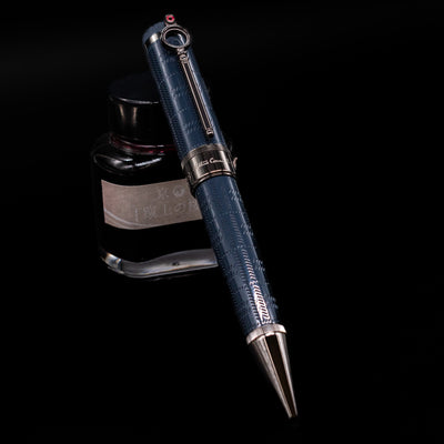 Montblanc Writer's Edition Sir Arthur Conan Doyle Ballpoint Pen - Preowned leaning against an ink bottle.
