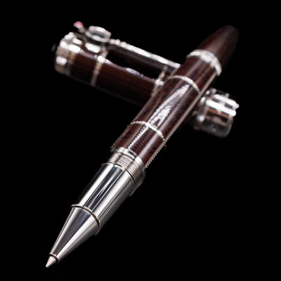 Montblanc Writer's Edition Sir Arthur Conan Doyle Limited Edition 1902 Rollerball Pen - Preowned laying across its own cap, crossed, with a focus on the tip.