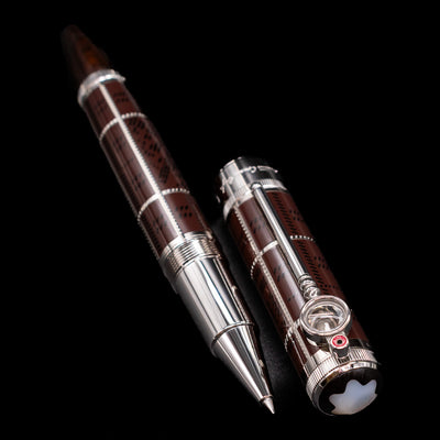 A full view of the Montblanc Writer's Edition Sir Arthur Conan Doyle Limited Edition 1902 Rollerball Pen - Preowned uncapped, with its cap laying next to the pen. 