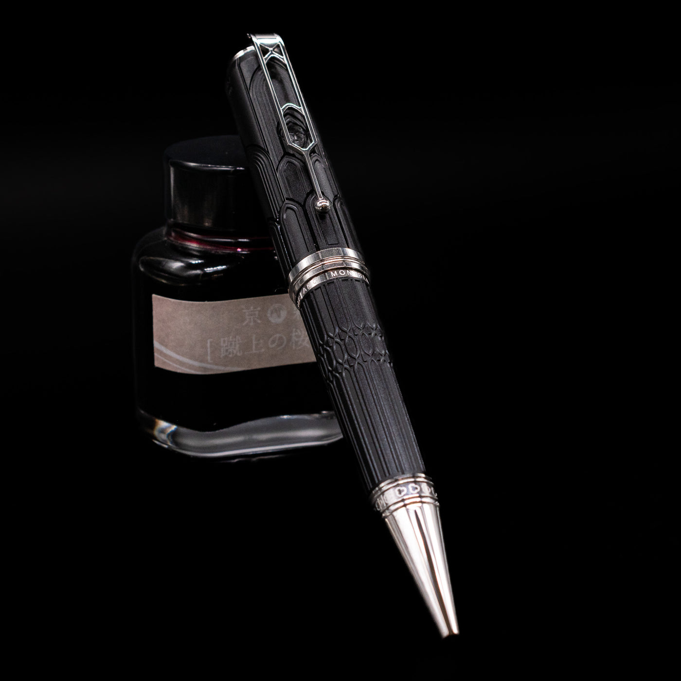 Montblanc Writer's Edition Victor Hugo Limited Edition Ballpoint Pen leaning on an ink bottle.