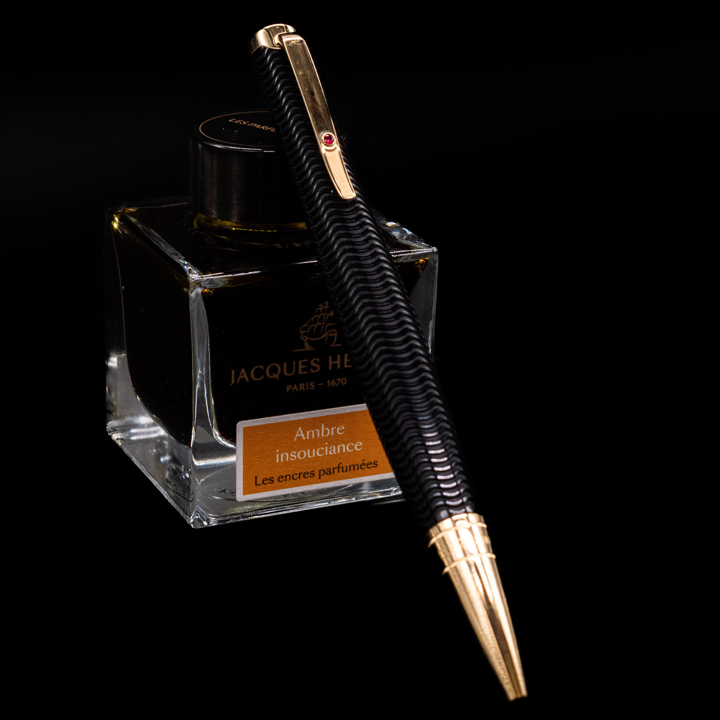 Montblanc Writer's Edition Virginia Woolf Ballpoint Pen - Preowned leaning on an ink bottle.