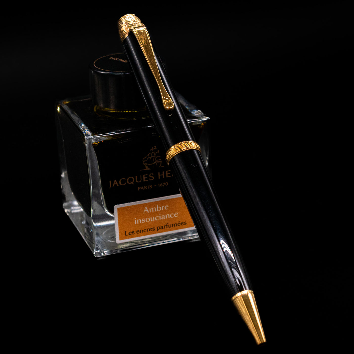 Montblanc Writer's Edition Voltaire Ballpoint Pen - Preowned leaning on an ink bottle.