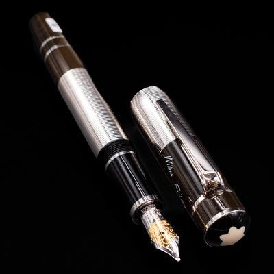 A full view of the Montblanc Writer's Edition William Faulkner Fountain Pen - Preowned uncapped, with its cap laying next to the pen. 