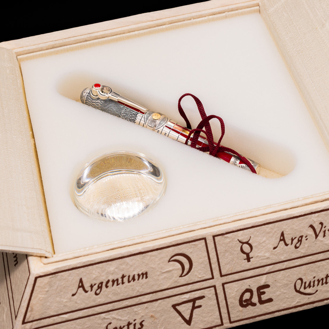 The lowest level opened on the alchemic pyramid  showcasing the glass loop and the Montegrappa Alchemist Ignis Rollerball Pen.