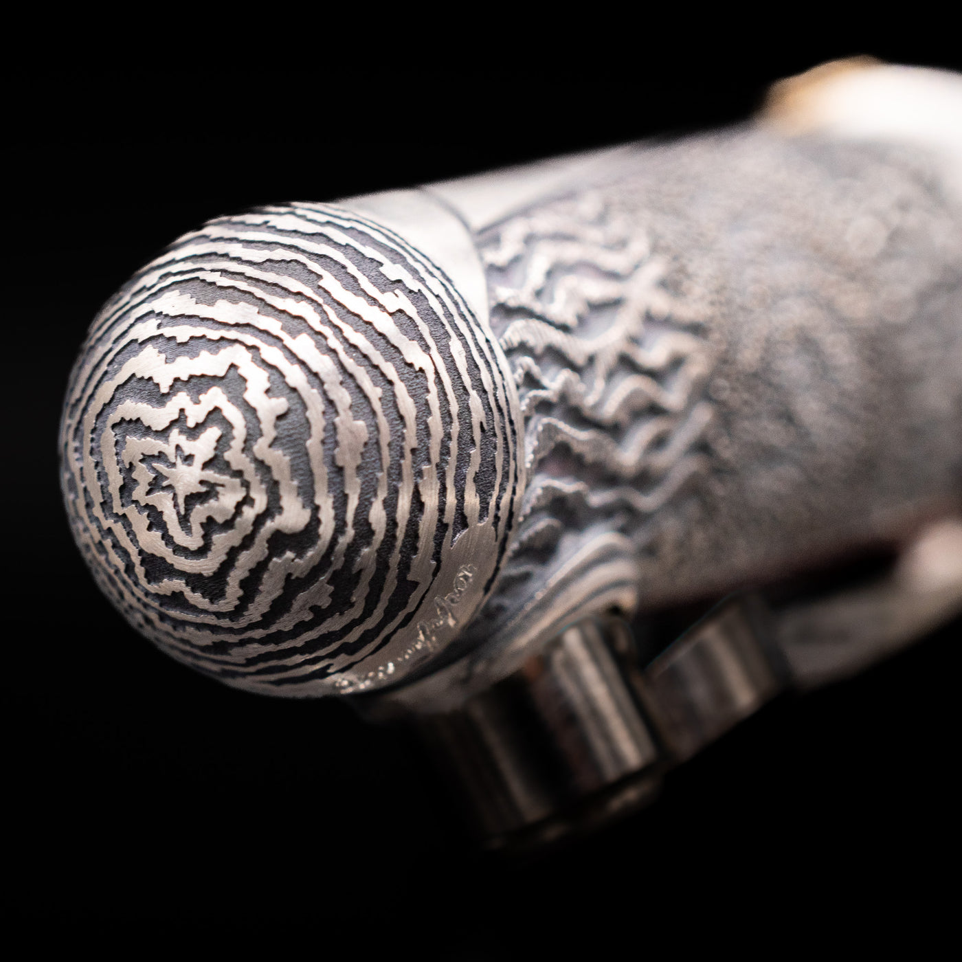Zoomed-in view of the top of the cap with the finial on the Montegrappa Alchemist Ignis Fountain Pen.