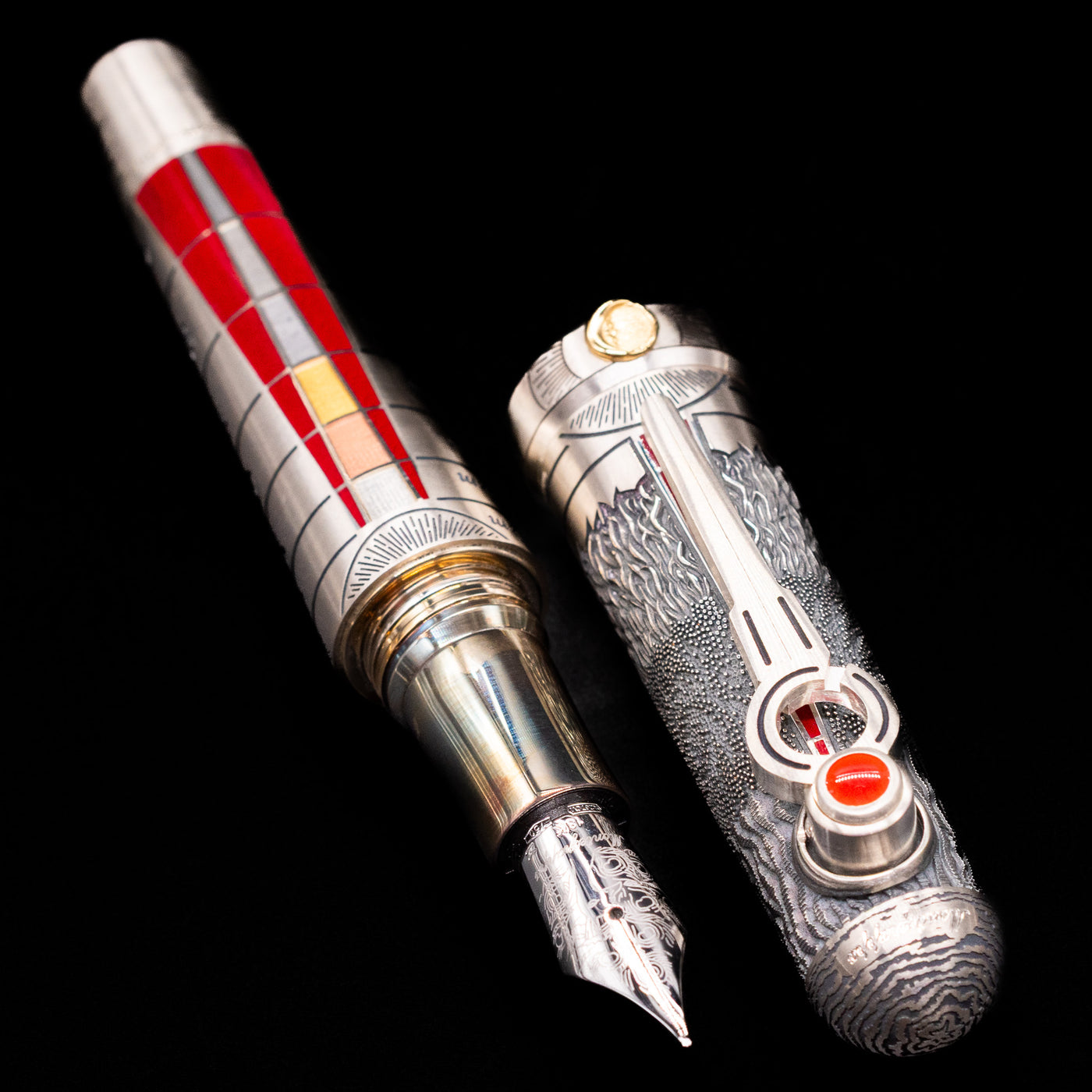  A full view of the Montegrappa Alchemist Ignis Fountain Pen uncapped, with its cap laying next to the pen. 