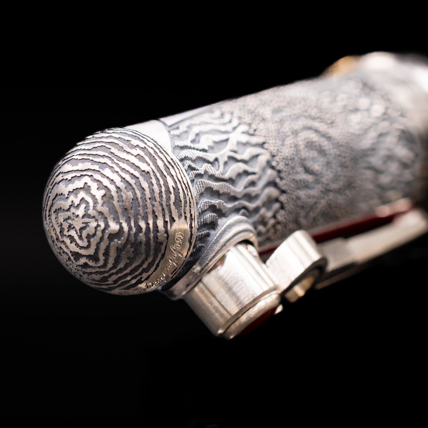 Zoomed-in view of the top of the cap with the finial on the Montegrappa Alchemist Ignis Rollerbal Pen.