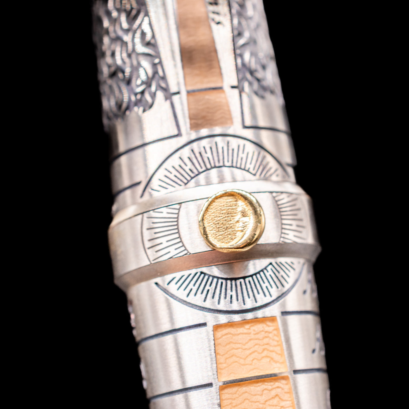 A detail shot of the moon on the middle ring on the Montegrappa Alchemist Terra Rollerball Pen.