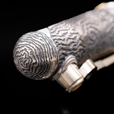 Zoomed-in view of the top of the cap with the finial on the Montegrappa Alchemist Terra Rollerball Pen.