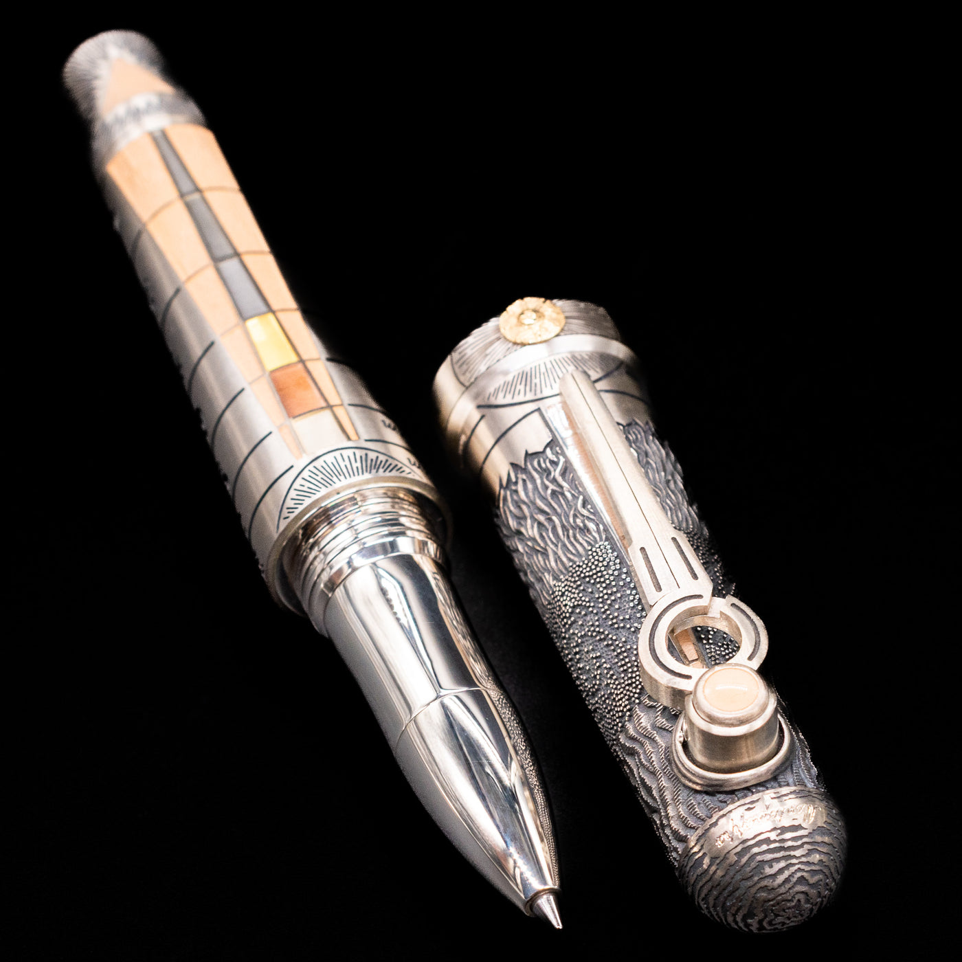A full view of the Montegrappa Alchemist Terra Rollerball Pen uncapped, with its cap laying next to the pen. 