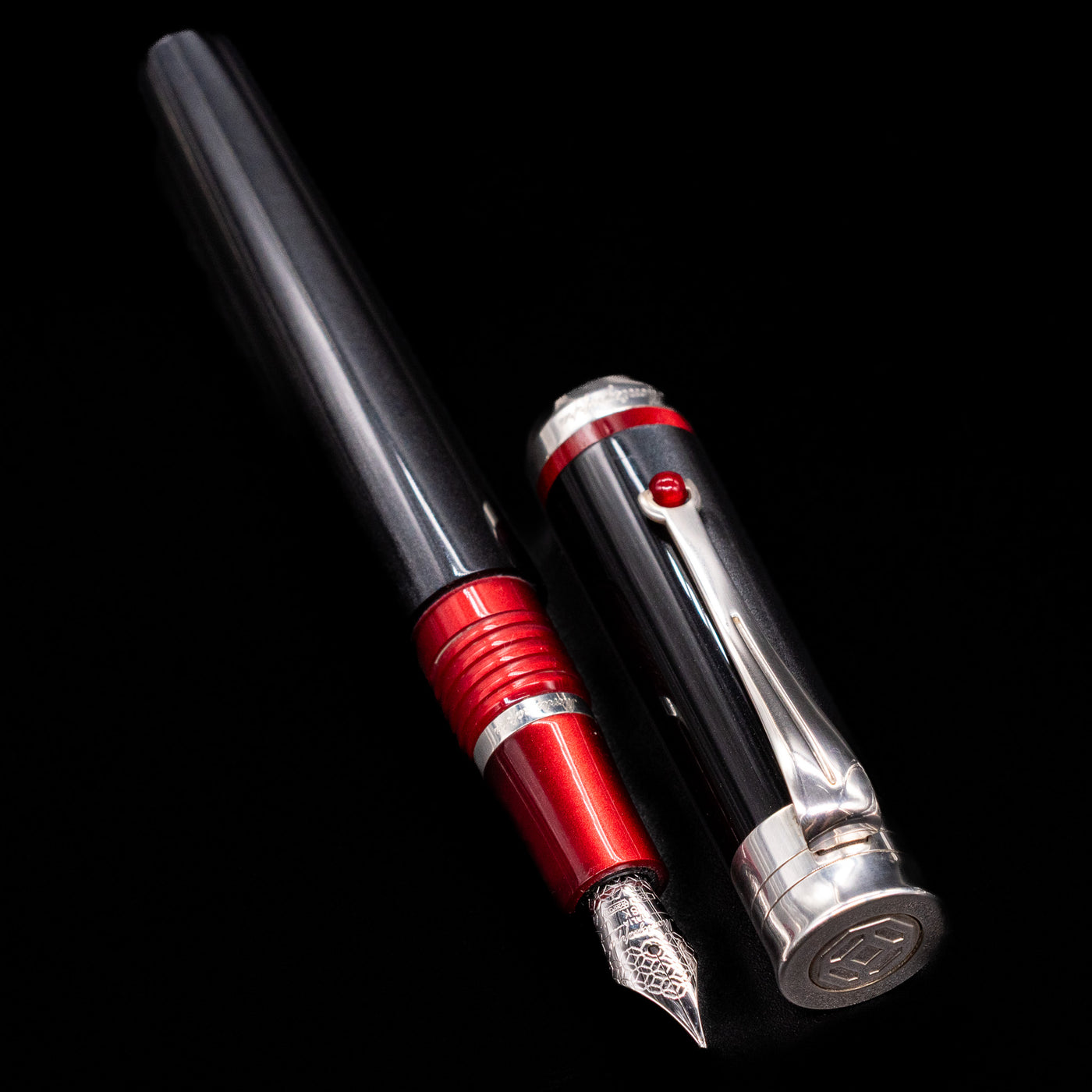 A full view of the Montegrappa Desiderio Black Fountain Pen - Preowned uncapped, with its cap laying next to the pen. 