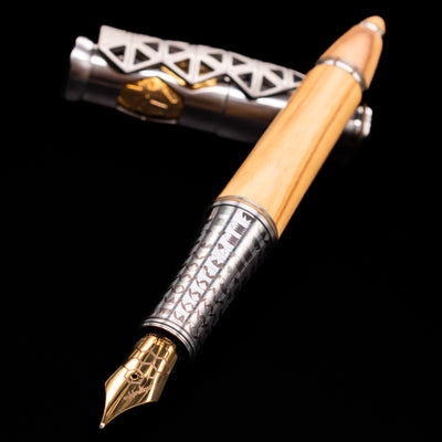 Montegrappa Leonardo da Vinci 500th Anniversary Fountain Pen laying across its own cap, crossed, with a focus on the nib.