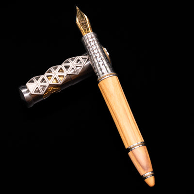Montegrappa Leonardo da Vinci 500th Anniversary Fountain Pen laying on top of its cap in a crossed position showing full view of the entire uncapped pen.