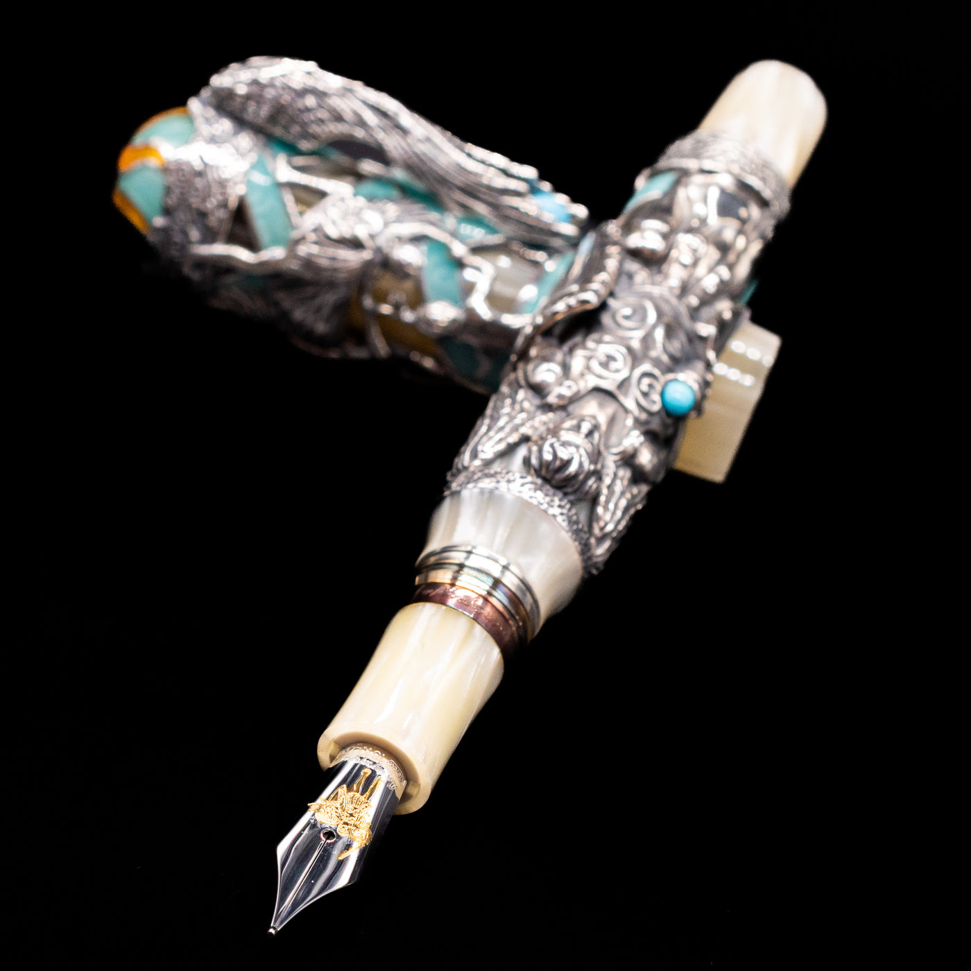 Montegrappa My Guardian Angel Fountain Pen laying across its own cap, crossed, with a focus on the nib.