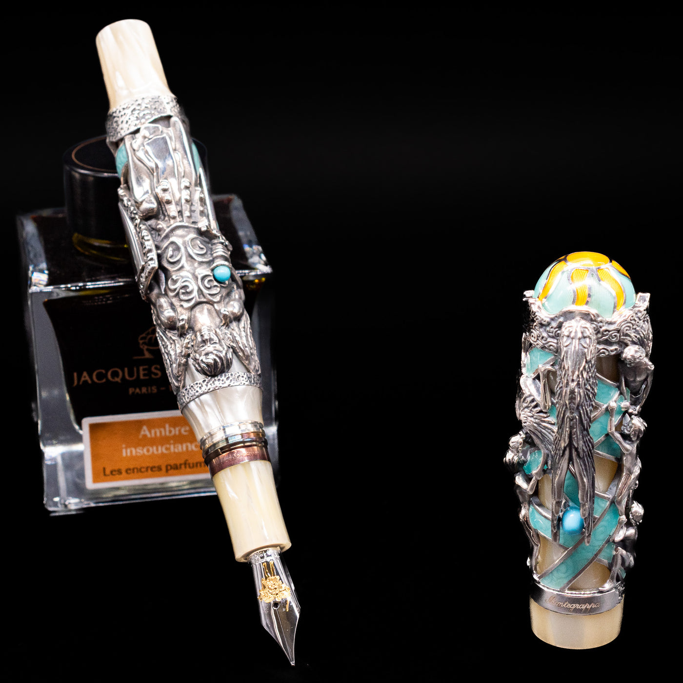 Montegrappa My Guardian Angel Fountain Pen leaning on an ink bottle uncapped showcasing the detailing on the nib.