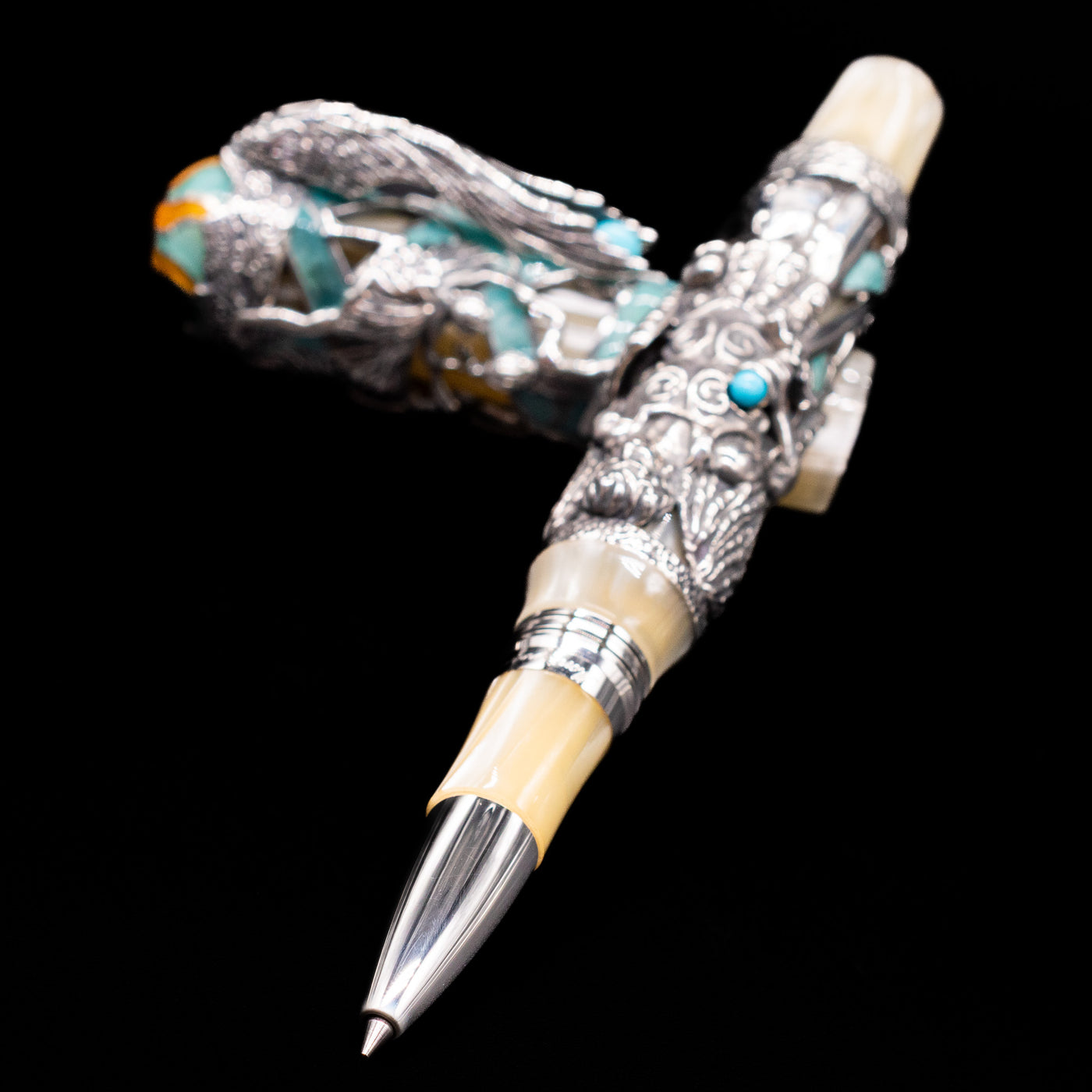 Montegrappa My Guardian Angel Rollerbal Pen laying across its own cap, crossed, with a focus on the tip.