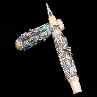 Montegrappa My Guardian Angel Rollerbal Pen laying on top of its cap in a crossed position showing full view of the entire uncapped pen.