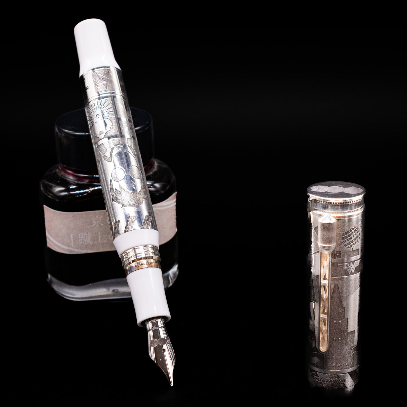 Montegrappa Warner Brothers 100th Anniversary Fountain Pen leaning on an ink bottle uncapped showcasing the detailing on the nib.