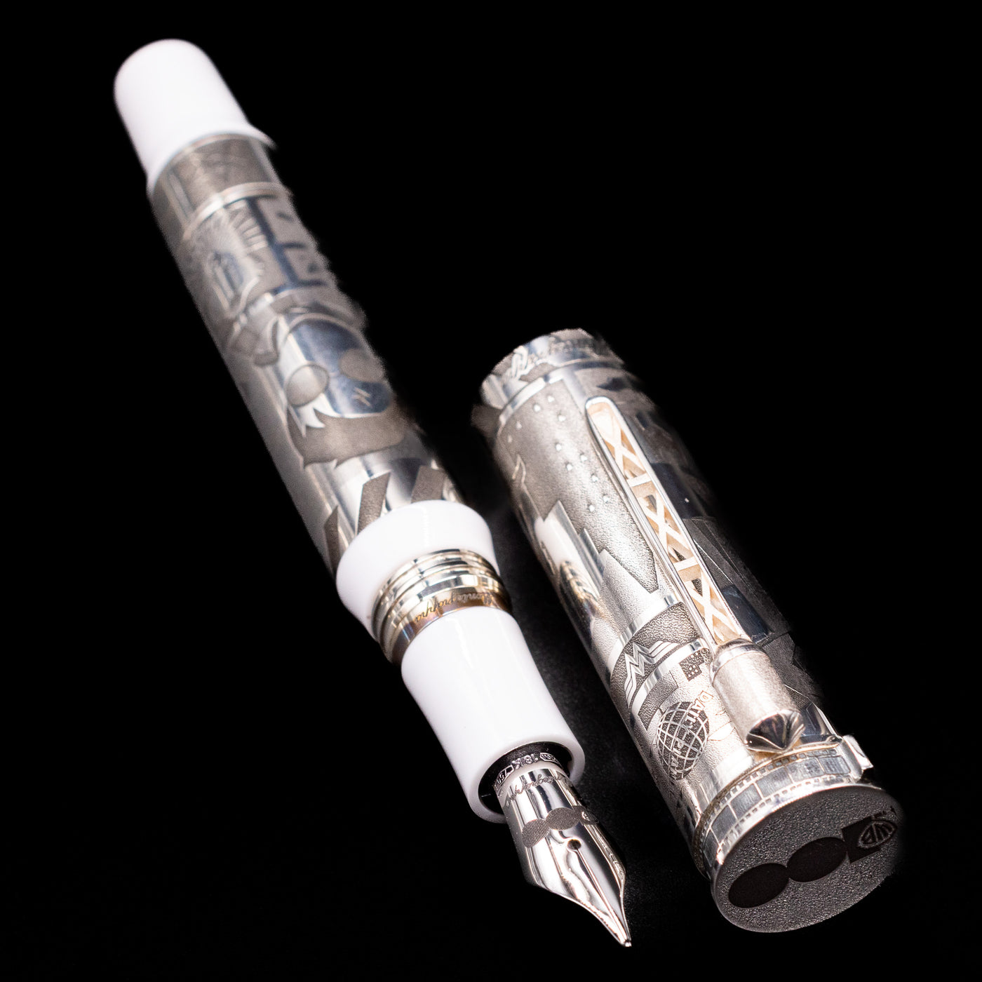  A full view of the Montegrappa Warner Brothers 100th Anniversary Fountain Pen uncapped, with its cap laying next to the pen. 