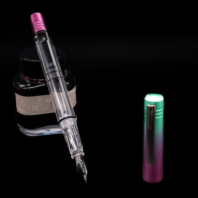 Monteverde MP1 Fountain Pen - Mermaid Tales leaning on an ink bottle uncapped showcasing the detailing on the nib.