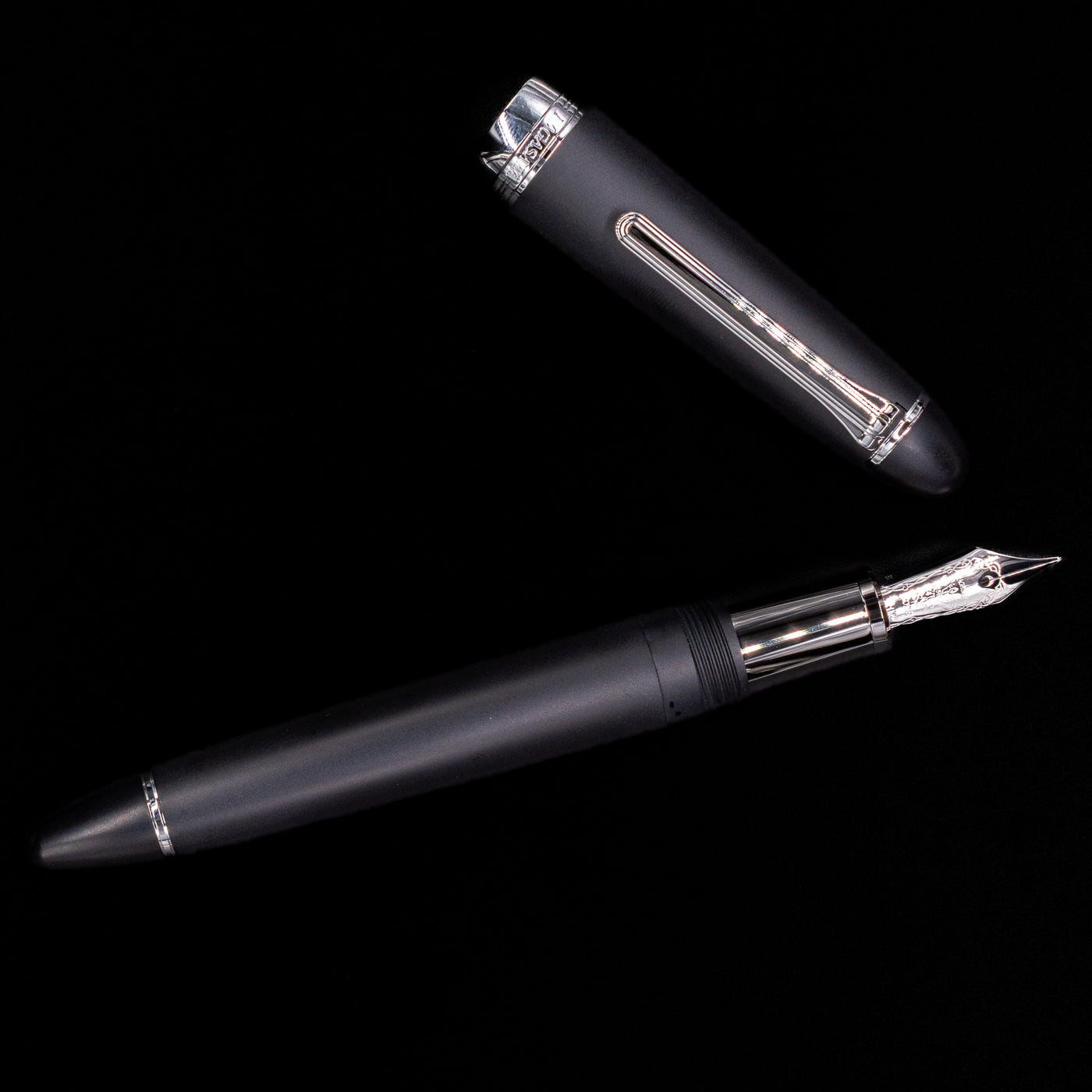 An overhead view of the Nagasawa Original Large Fountain Pen - Black & Silver FL (For Lawyer) uncapped.