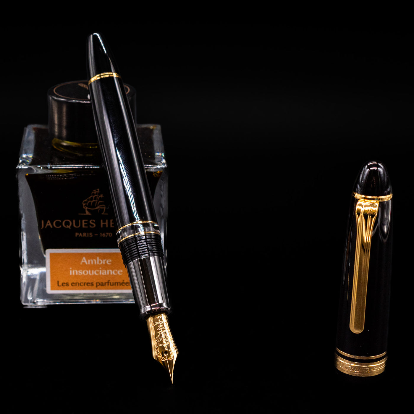 Nagasawa Original Large Piston Fountain Pen - Realo FL (For Lawyer) leaning on an ink bottle uncapped showcasing the detailing on the nib.