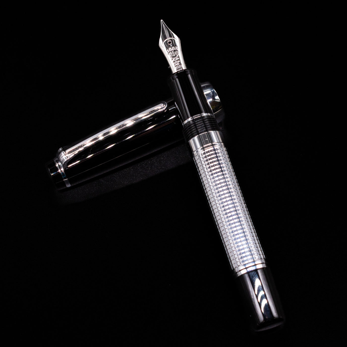 Nagasawa Original Limited Edition Fountain Pen - Engrave Kou laying on top of its cap in a crossed position showing full view of the entire uncapped pen.
