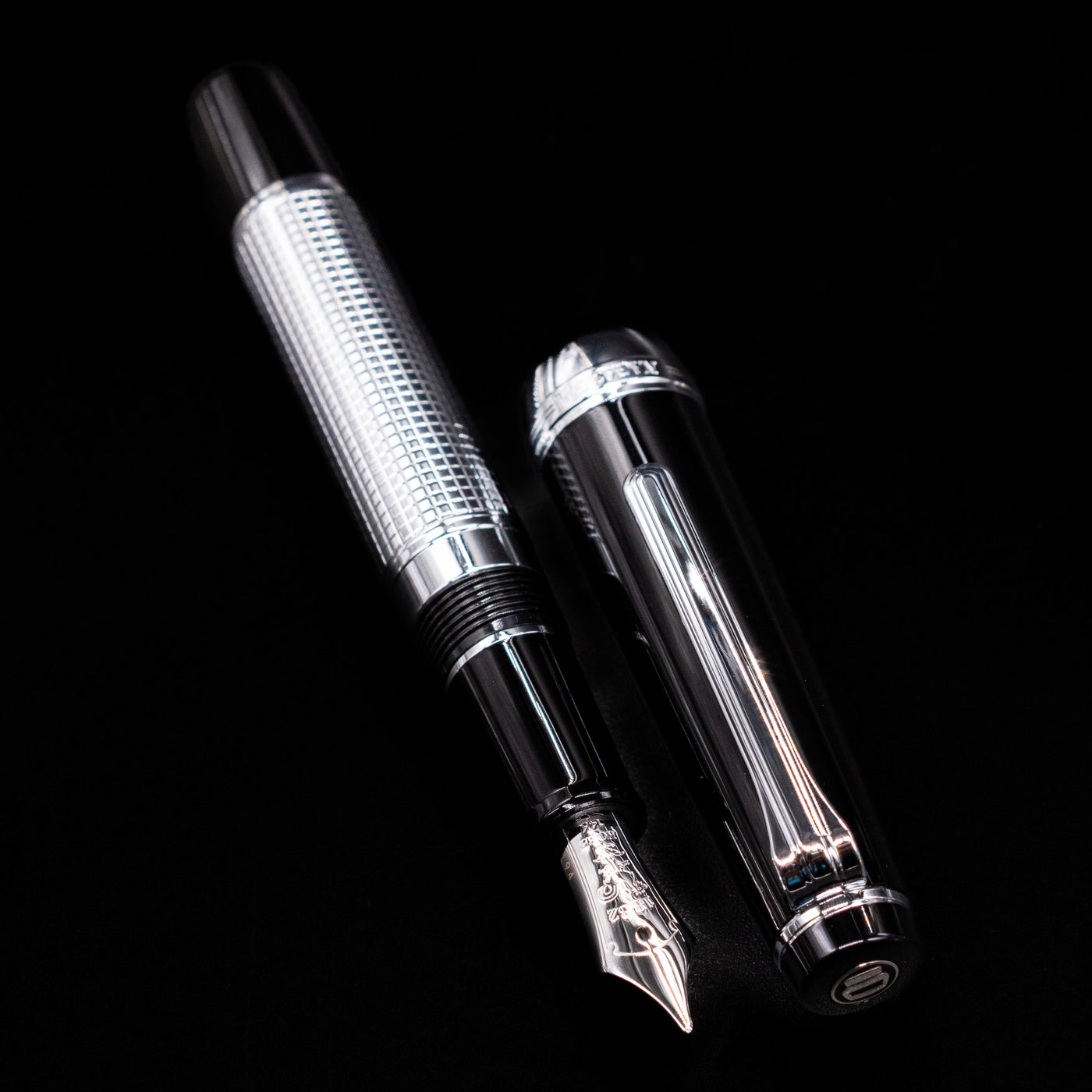 A full view of the Nagasawa Original Limited Edition Fountain Pen - Engrave Kou uncapped, with its cap laying next to the pen. 