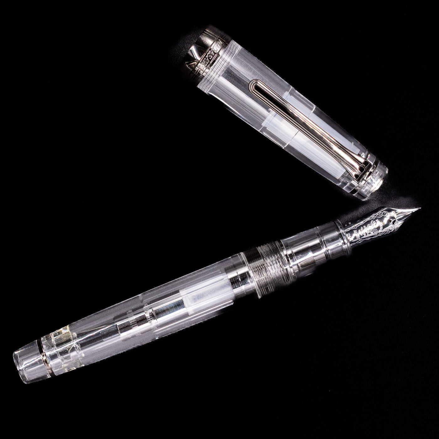 An overhead view of the Nagasawa Original Professional Gear Fountain Pen - Skeleton Black uncapped.