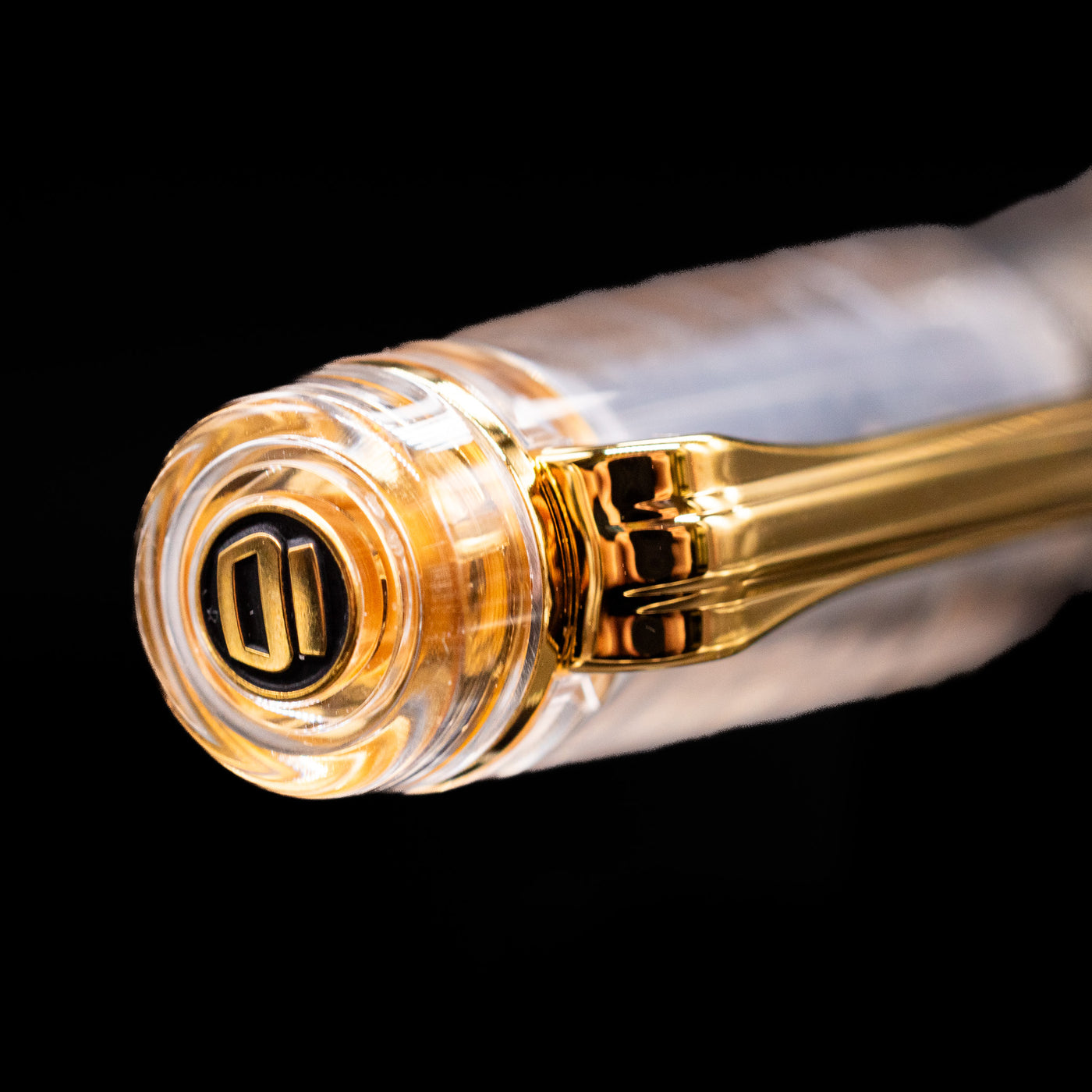 Zoomed-in view of the top of the cap with the finial on the Nagasawa Original Professional Gear Fountain Pen - Skeleton Gold.