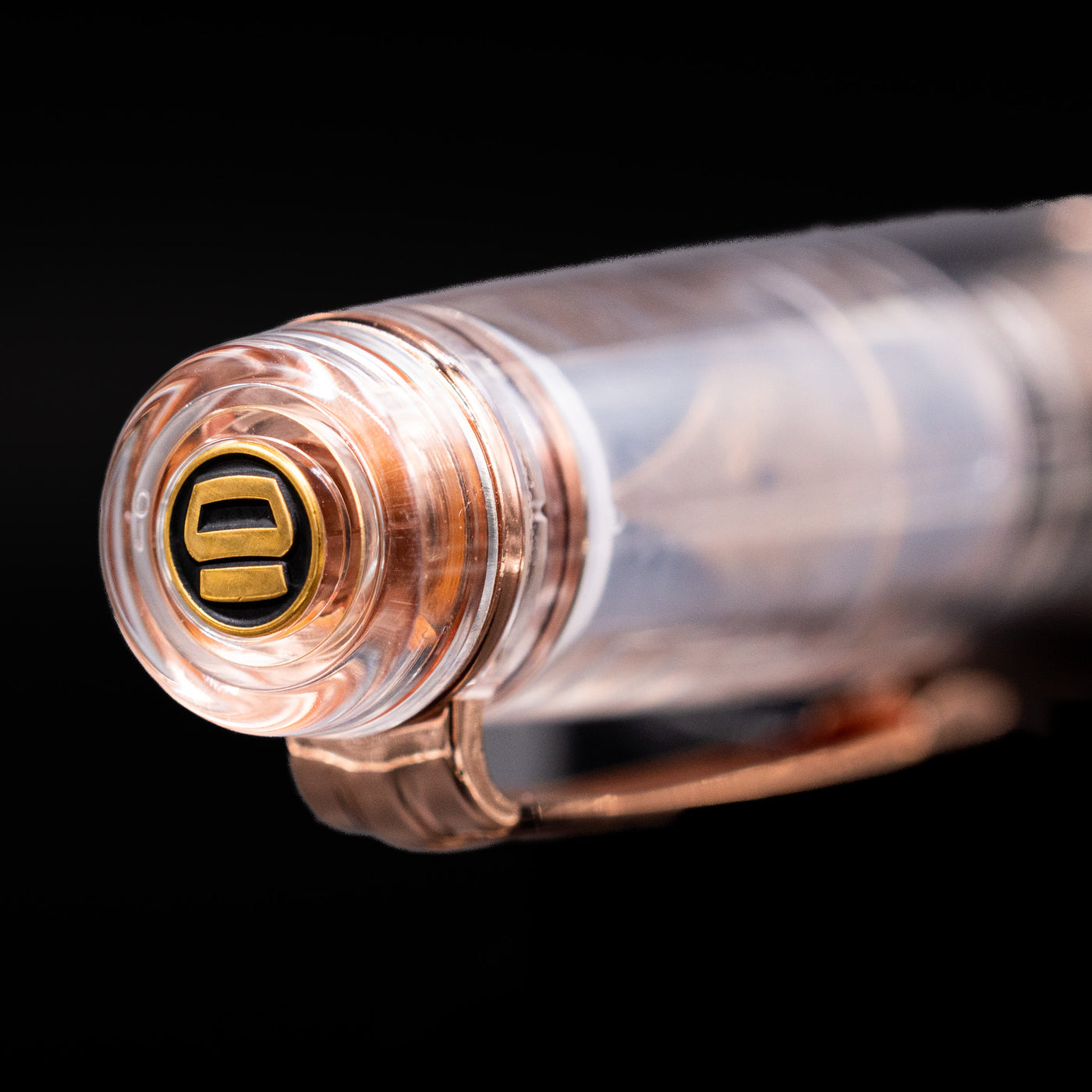 Zoomed-in view of the top of the cap with the finial on the Nagasawa Original Professional Gear Fountain Pen - Skeleton Pink Gold.