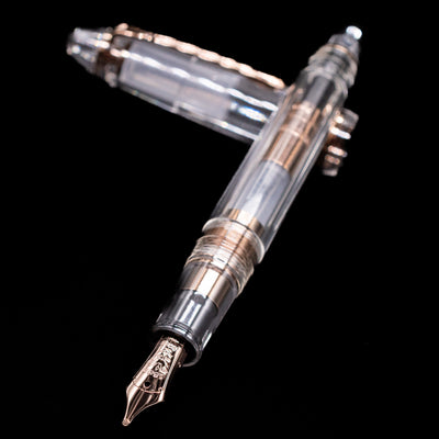 Nagasawa Original Standard Fountain Pen - Skeleton Proske Antique Gold laying across its own cap, crossed, with a focus on the nib.