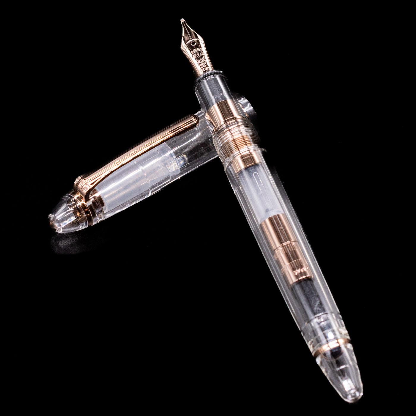 Nagasawa Original Standard Fountain Pen - Skeleton Proske Antique Gold laying on top of its cap in a crossed position showing full view of the entire uncapped pen.