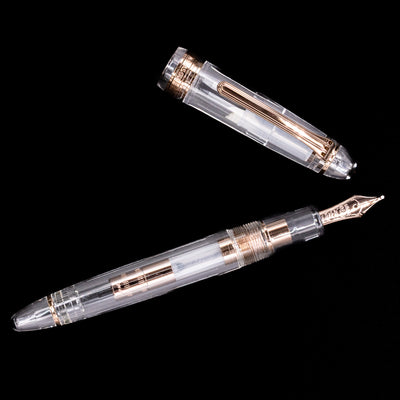 An overhead view of the Nagasawa Original Standard Fountain Pen - Skeleton Proske Antique Gold uncapped.