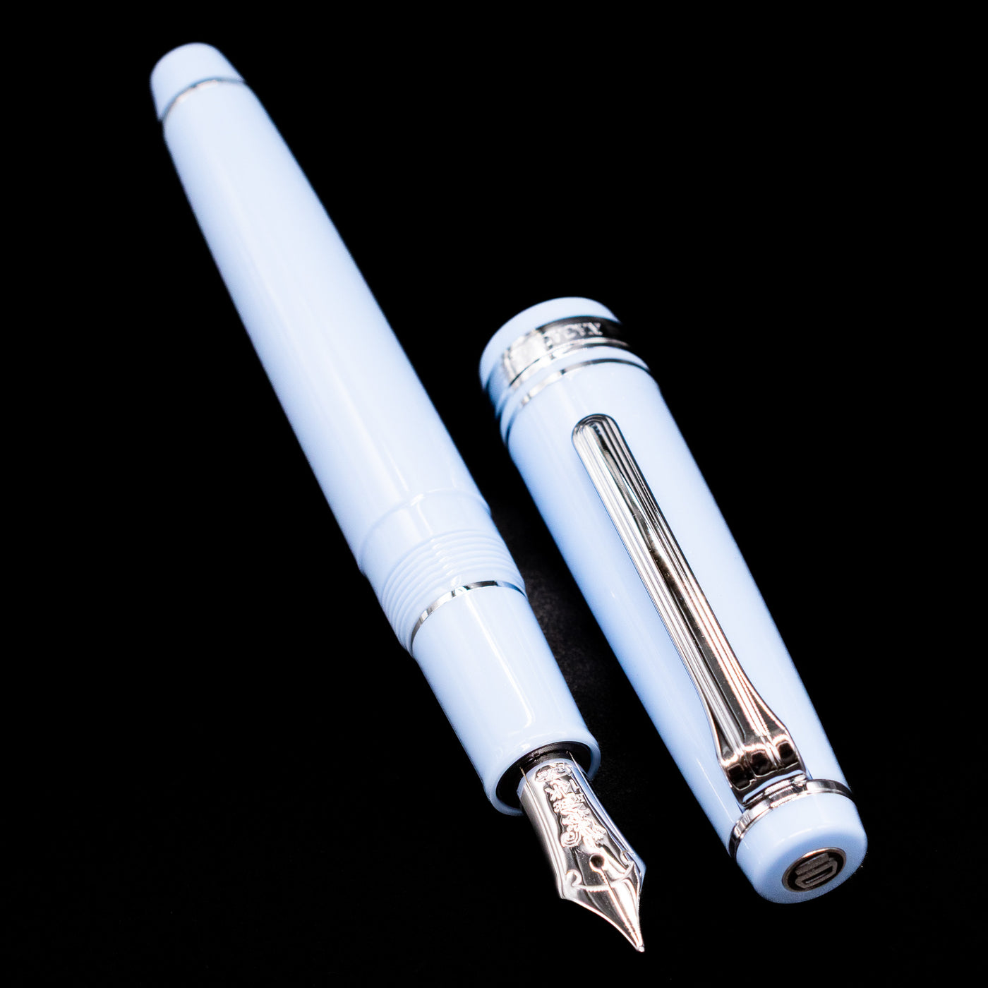 A full view of the Nagasawa Original Standard Rokko Fountain Pen - Island Sky uncapped, with its cap laying next to the pen.