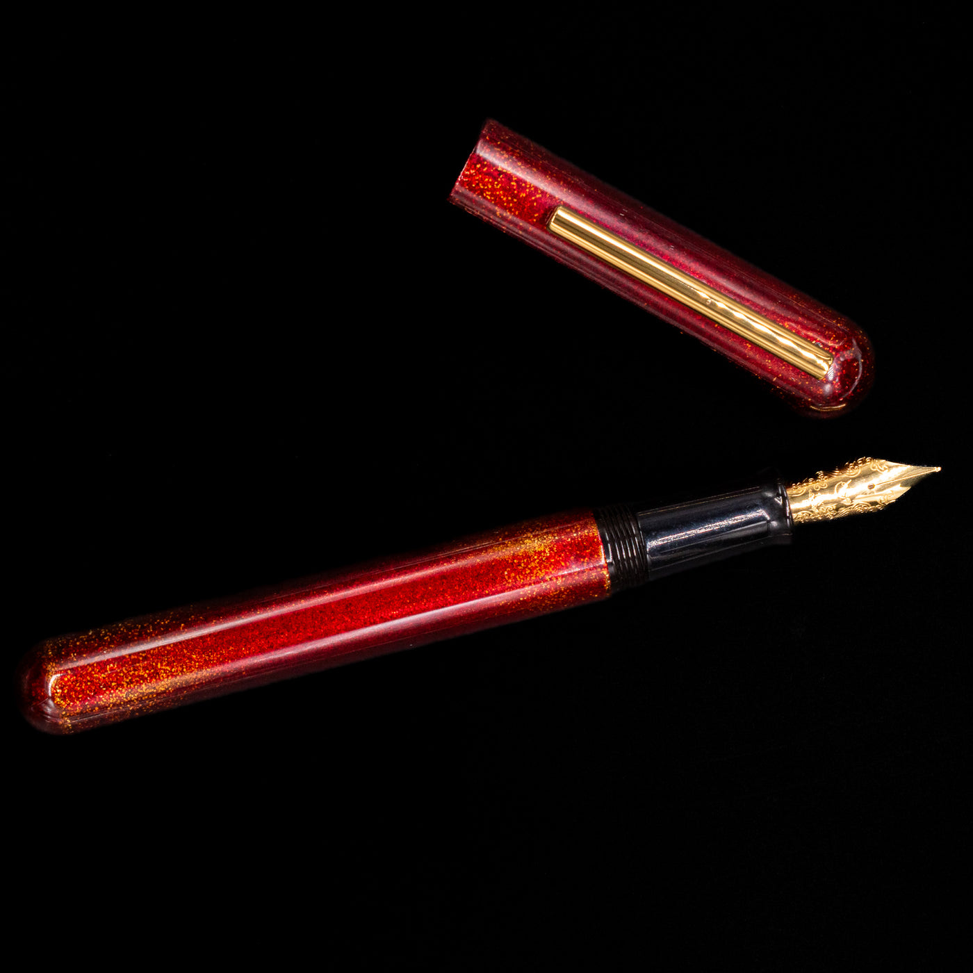 An overhead view of the Nahvalur Ikkaku Urushi Fountain Pen - Blood Moon uncapped.